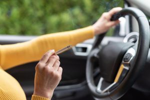 Smoking while driving, Woman smoking a cigarette while driving